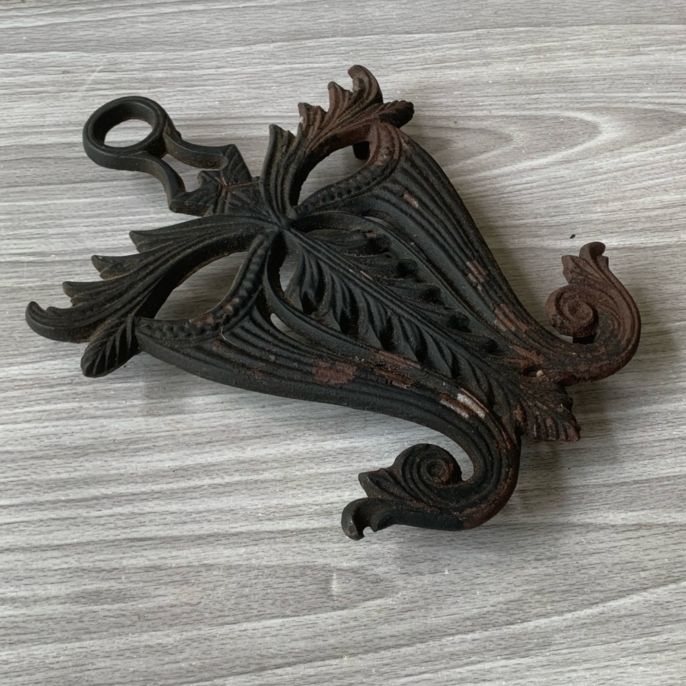 Cast iron stand trivet. Some flaking. See all photos for condition and measureme